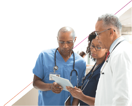 three doctors looking at the tablet